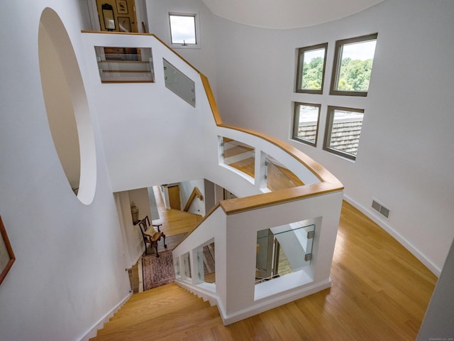 48 Andrews Rd, Guilford, CT 06437 - stairs with wood finished floors, baseboards, and arched walkways