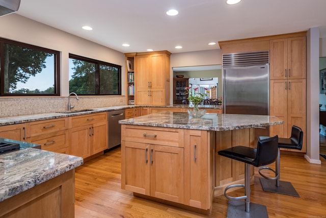 48 Andrews Rd, Guilford, CT 06437 - kitchen with stainless steel appliances, a sink, light wood finished floors, light stone counters, and recessed lighting
