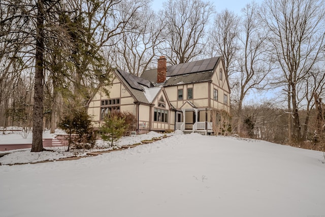 tudor house featuring solar panels