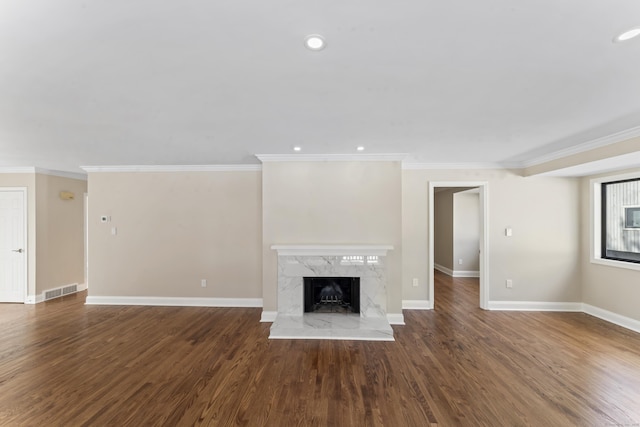 unfurnished living room featuring recessed lighting, wood finished floors, visible vents, baseboards, and a fireplace