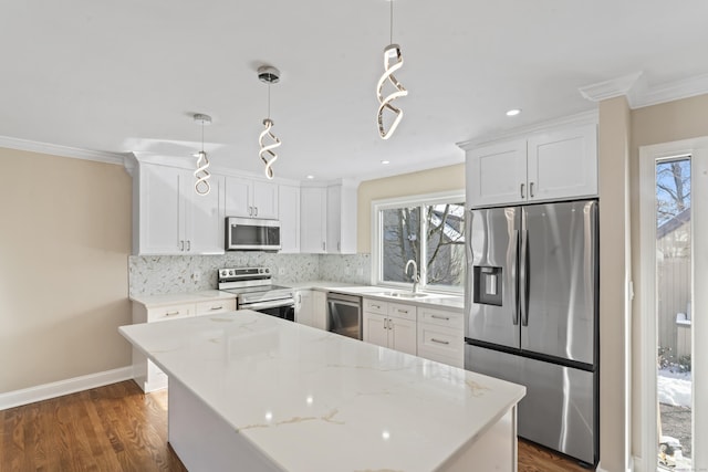 kitchen with a wealth of natural light, decorative backsplash, stainless steel appliances, and a sink