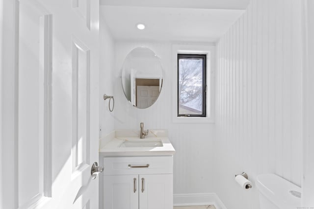 half bath featuring toilet and vanity