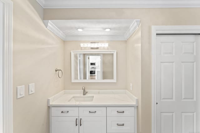 bathroom with ornamental molding and vanity