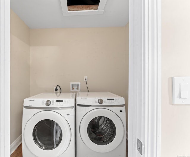 clothes washing area with washing machine and clothes dryer and laundry area