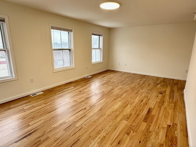 spare room with light hardwood / wood-style floors