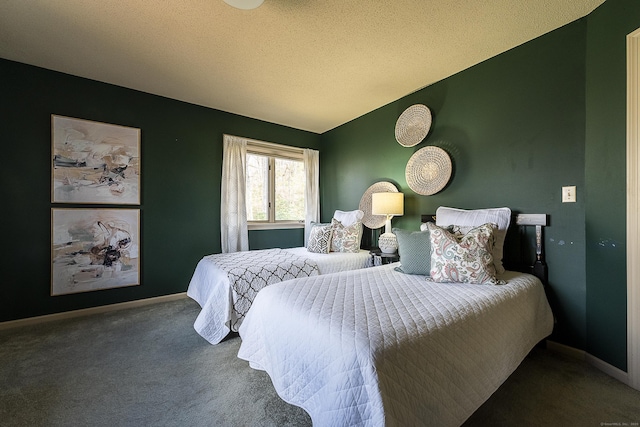 bedroom featuring baseboards, a textured ceiling, and carpet