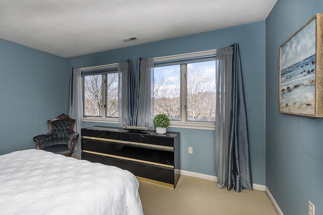 bedroom with visible vents, carpet, and baseboards