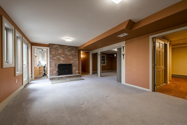 unfurnished living room featuring carpet floors, baseboards, a brick fireplace, and visible vents