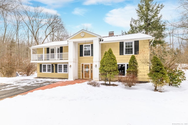 greek revival inspired property featuring a balcony