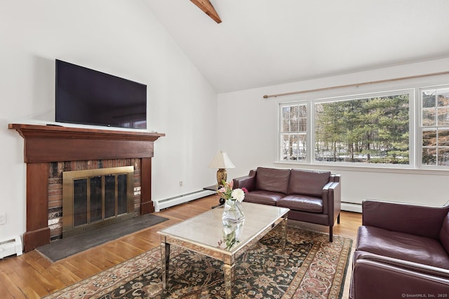 living room featuring a baseboard heating unit, hardwood / wood-style flooring, vaulted ceiling, and a brick fireplace