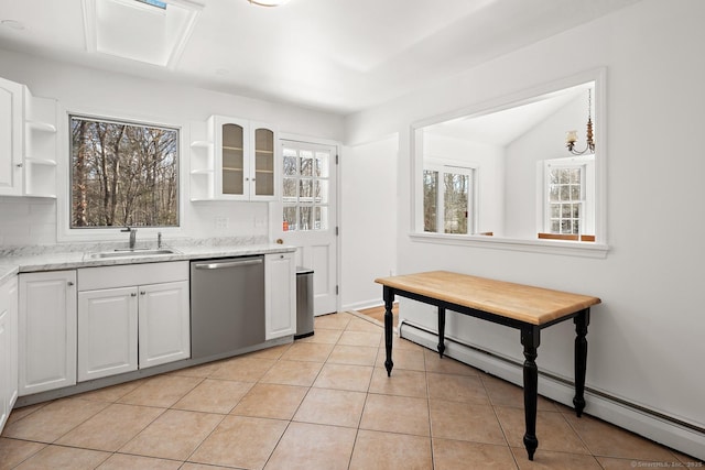 kitchen with sink, stainless steel dishwasher, white cabinets, and light stone countertops