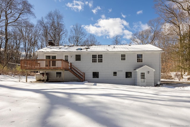 snow covered property featuring a deck