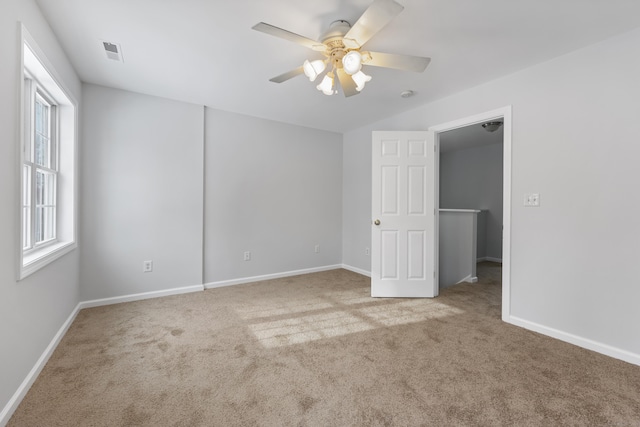 unfurnished room featuring ceiling fan and carpet