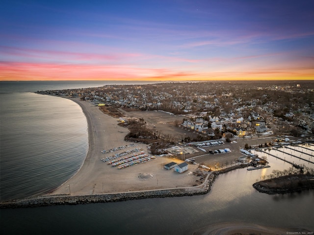 birds eye view of property featuring a water view and a beach view