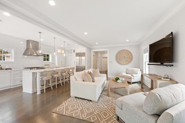 living area featuring recessed lighting, dark wood-style flooring, and crown molding