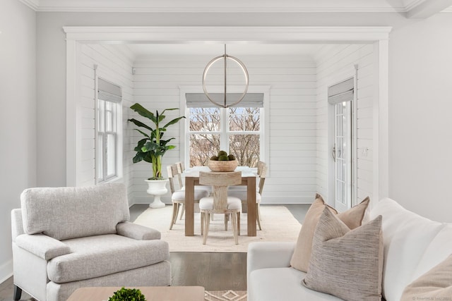 dining area with ornamental molding and wood finished floors