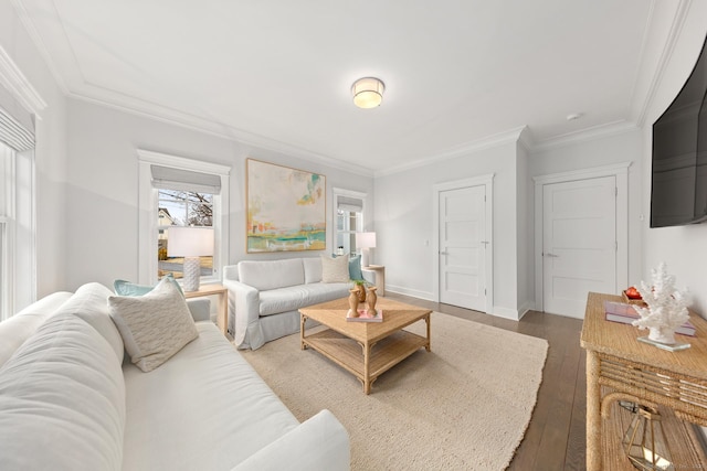 living area with baseboards, wood finished floors, and crown molding