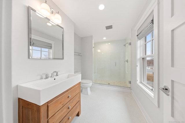 bathroom with a stall shower, baseboards, visible vents, toilet, and vanity