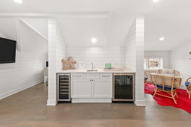 kitchen featuring beverage cooler, dark wood-type flooring, and lofted ceiling