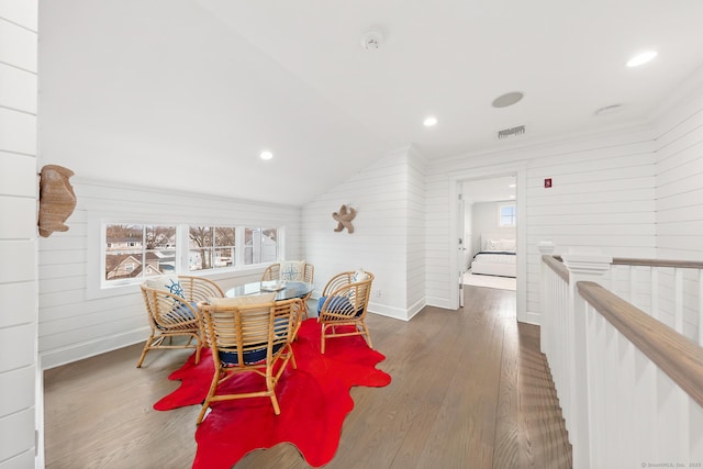 dining area with crown molding, visible vents, and wood finished floors