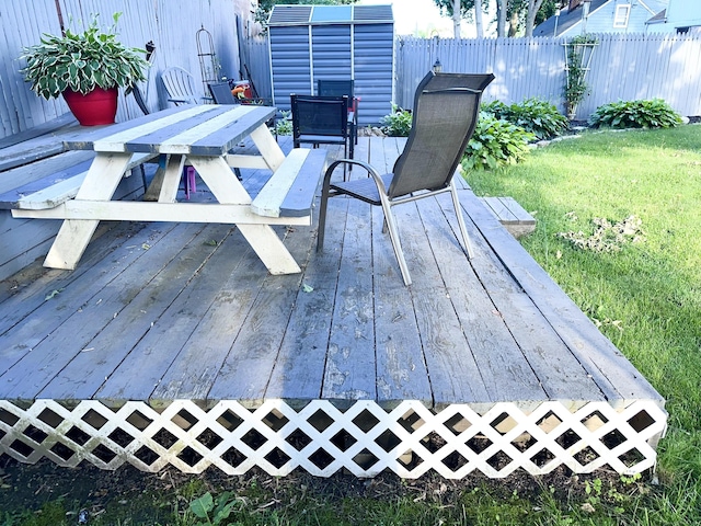 wooden deck featuring a lawn