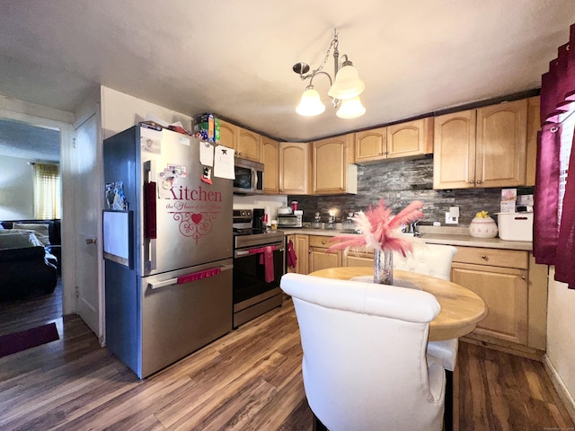 kitchen with pendant lighting, appliances with stainless steel finishes, dark hardwood / wood-style floors, and light brown cabinetry