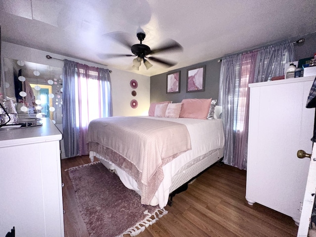 bedroom with dark hardwood / wood-style floors and ceiling fan