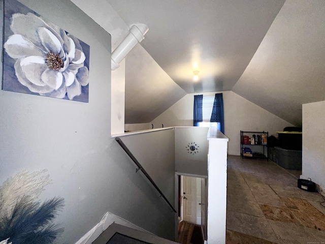 staircase featuring lofted ceiling