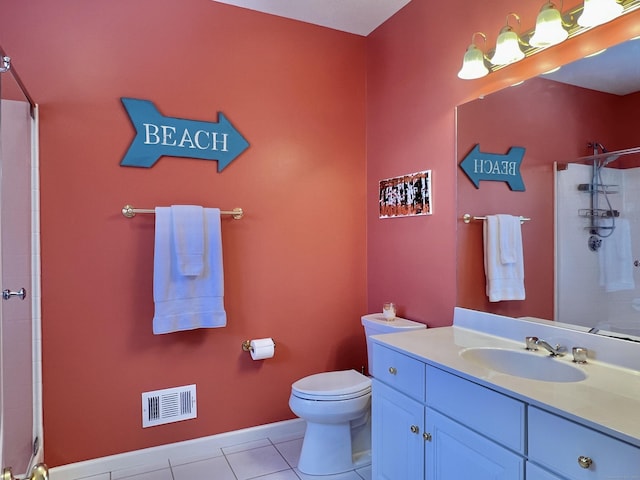 bathroom featuring tile patterned floors, toilet, a shower with door, and vanity