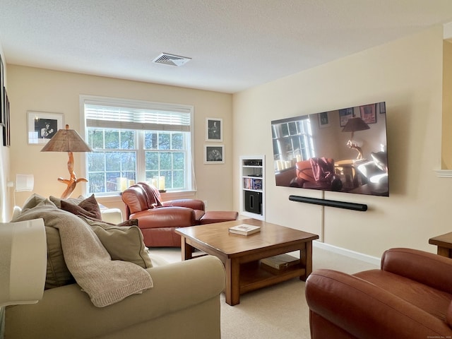 living room featuring light colored carpet and a textured ceiling