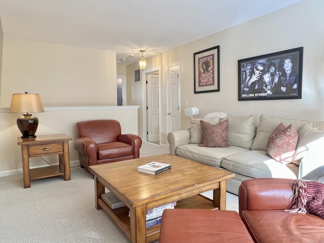 carpeted living room featuring a textured ceiling