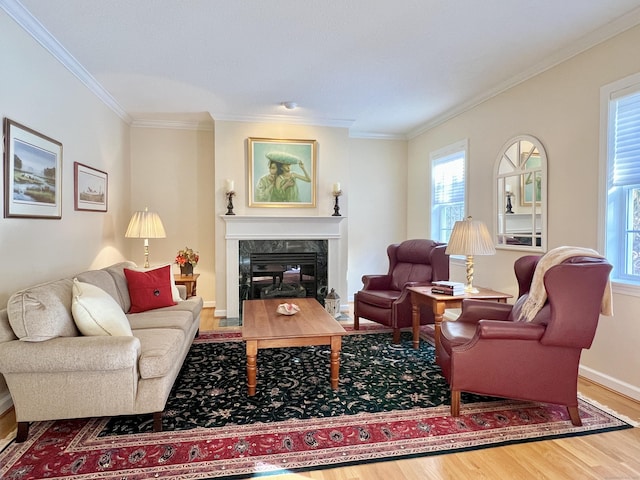 living room with ornamental molding, a high end fireplace, and hardwood / wood-style floors