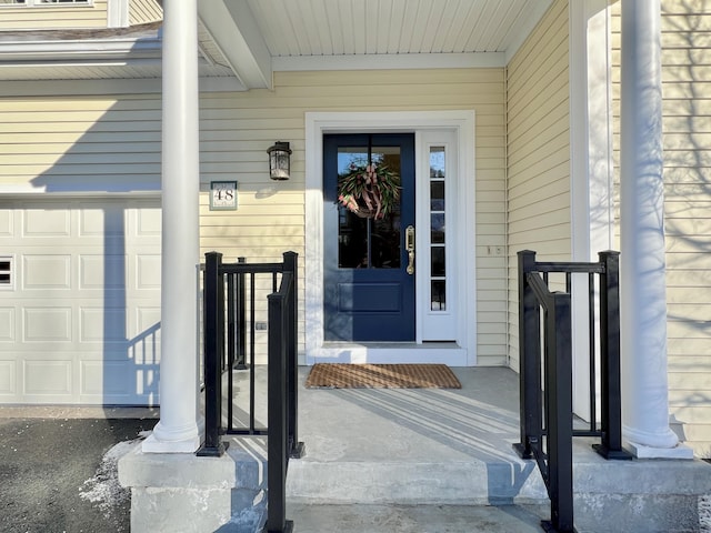 doorway to property with a garage