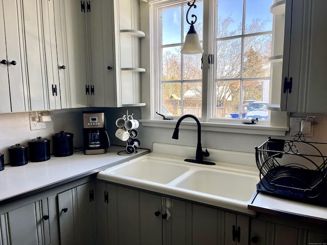 kitchen with sink, hanging light fixtures, and gray cabinetry