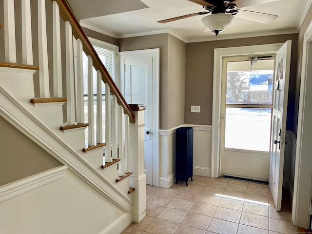 entryway featuring crown molding, a healthy amount of sunlight, and radiator