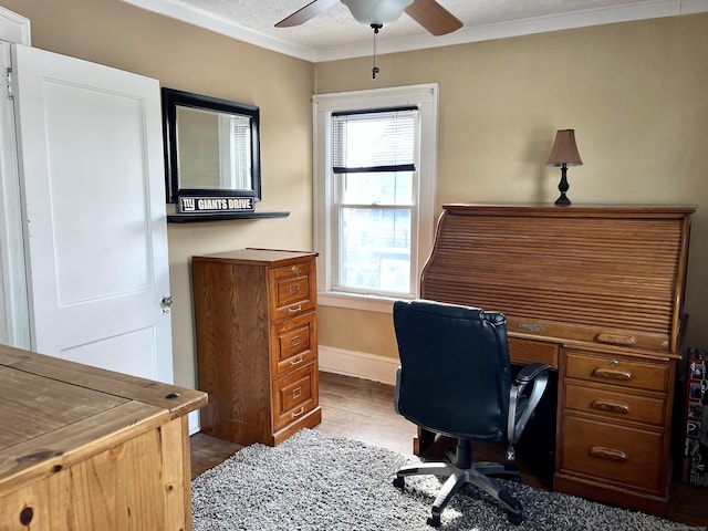 office space with dark wood-type flooring, ceiling fan, and ornamental molding