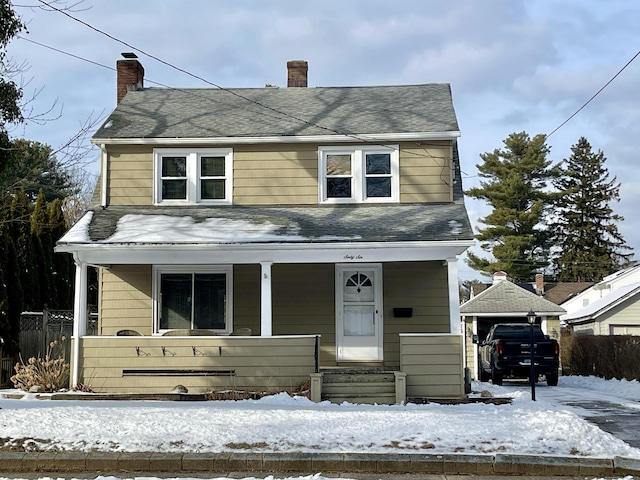 view of front of property featuring a garage and a porch