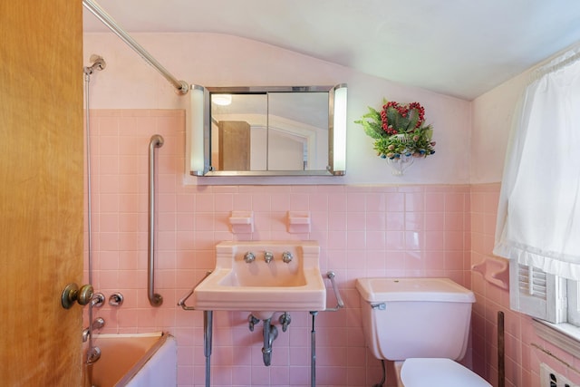 bathroom featuring shower / tub combination, a sink, toilet, and tile walls