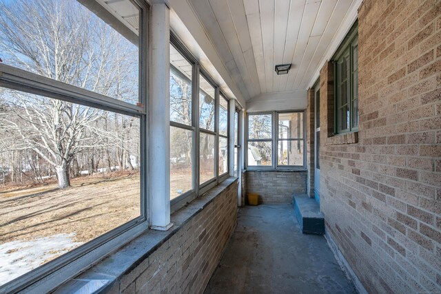 unfurnished sunroom with wood ceiling