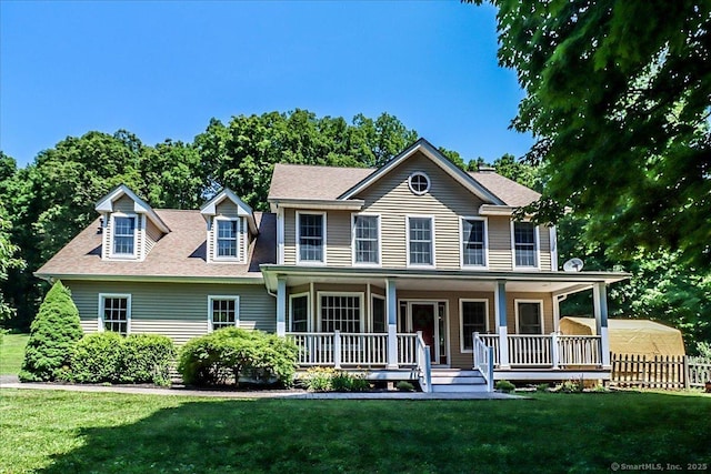 colonial-style house with covered porch and a front yard