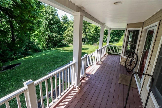 wooden deck featuring a yard and a porch