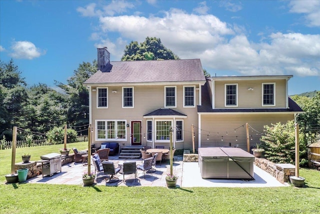 back of house with a yard and a patio