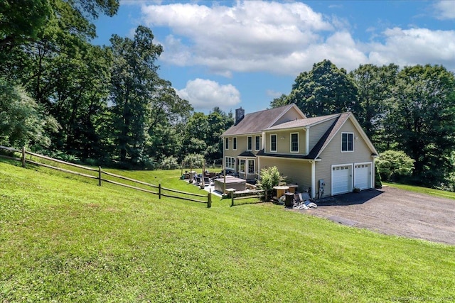 view of front of home featuring a garage and a front lawn