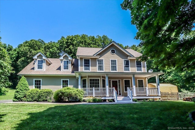 colonial home with a porch and a front lawn