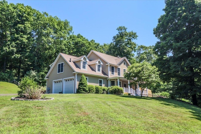 view of front of property with a porch, a garage, and a front yard