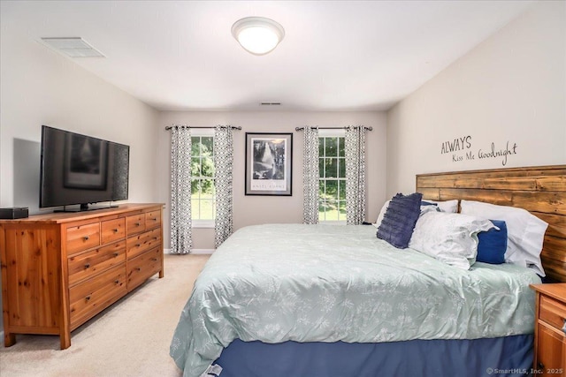 bedroom featuring light carpet