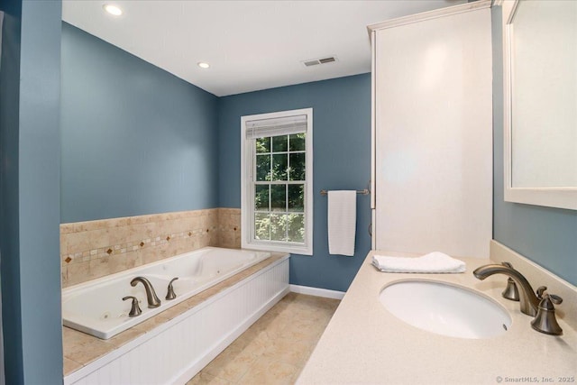 bathroom featuring vanity, tile patterned floors, and a bathing tub