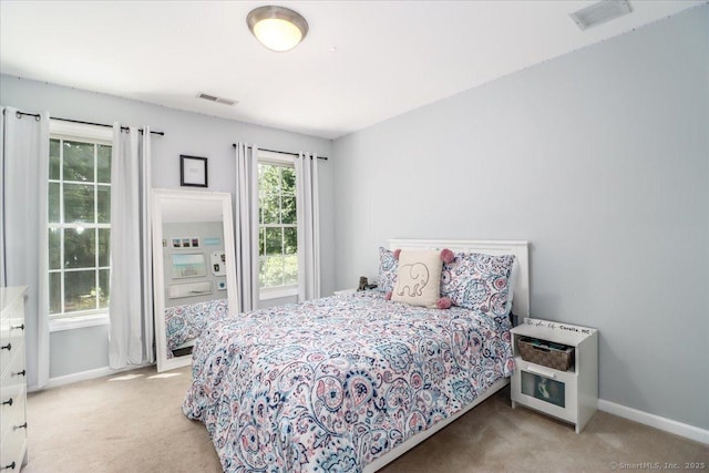 bedroom featuring light carpet