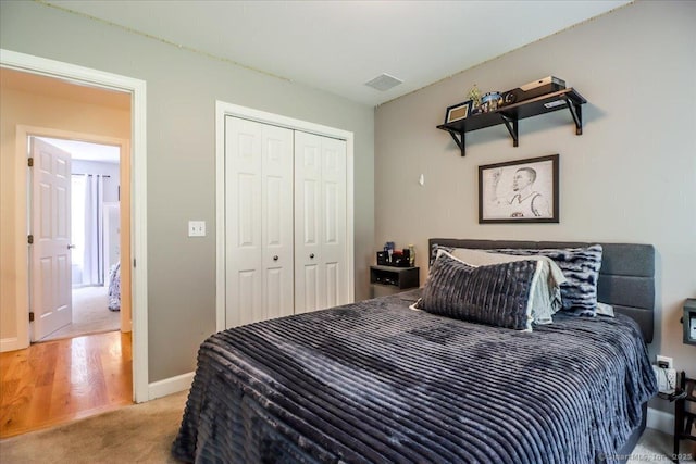 bedroom with light colored carpet and a closet