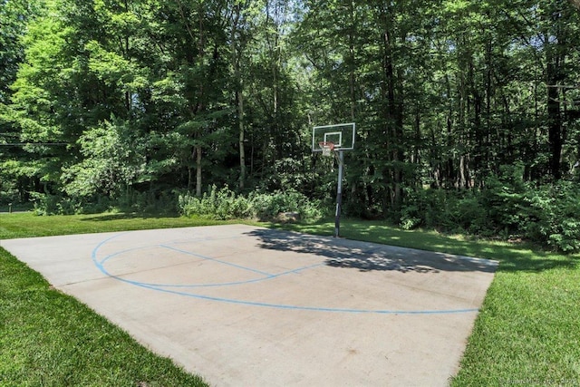 view of basketball court featuring a yard